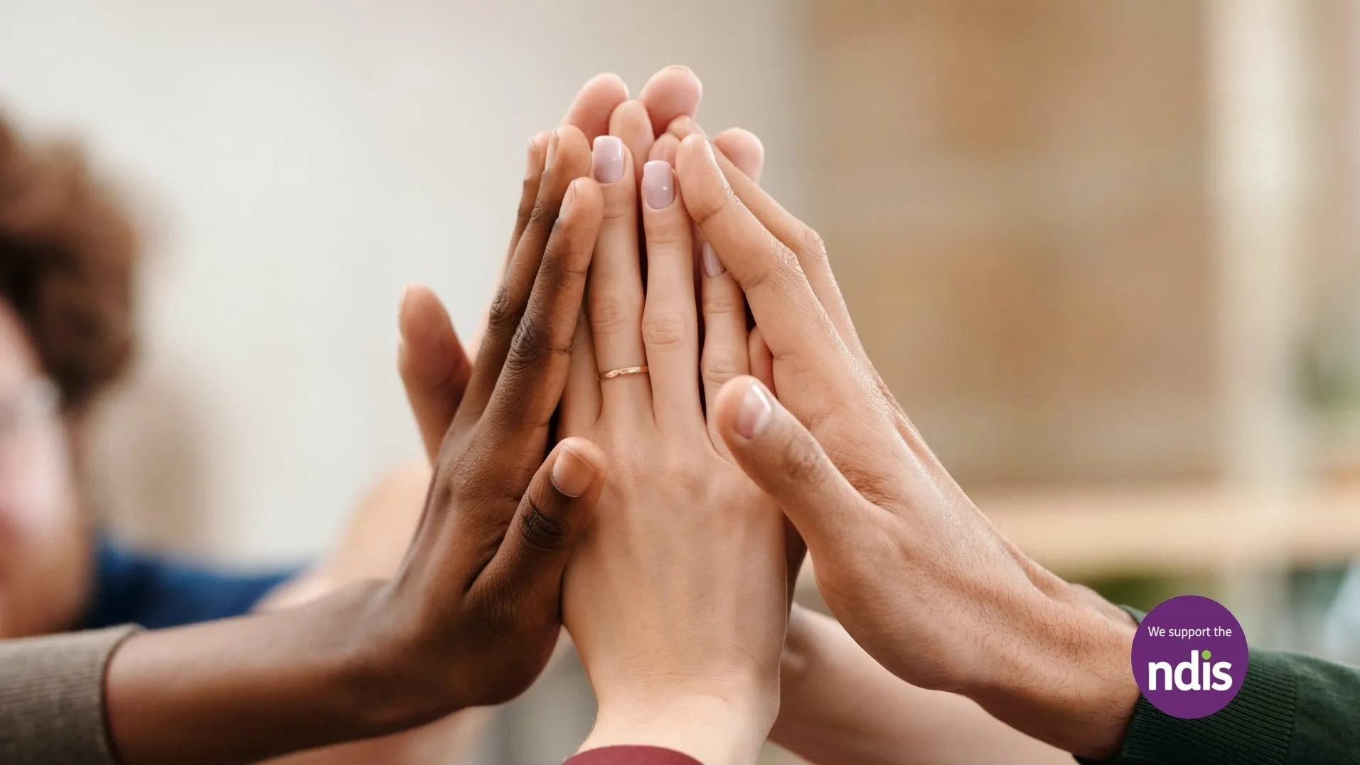 Diverse hands together - We support the NDIS